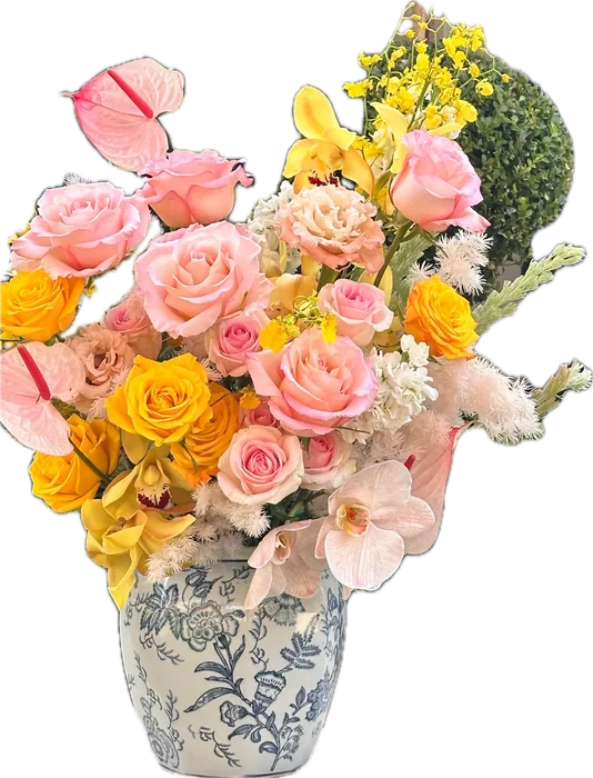 Sunburst Vase Arrangement: pink and yellow roses, orchids and anthurium in a blue-and-white vase