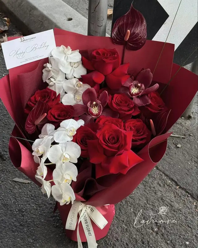Abundant Heart Bouquet of red roses and white orchids with a Happy Birthday card