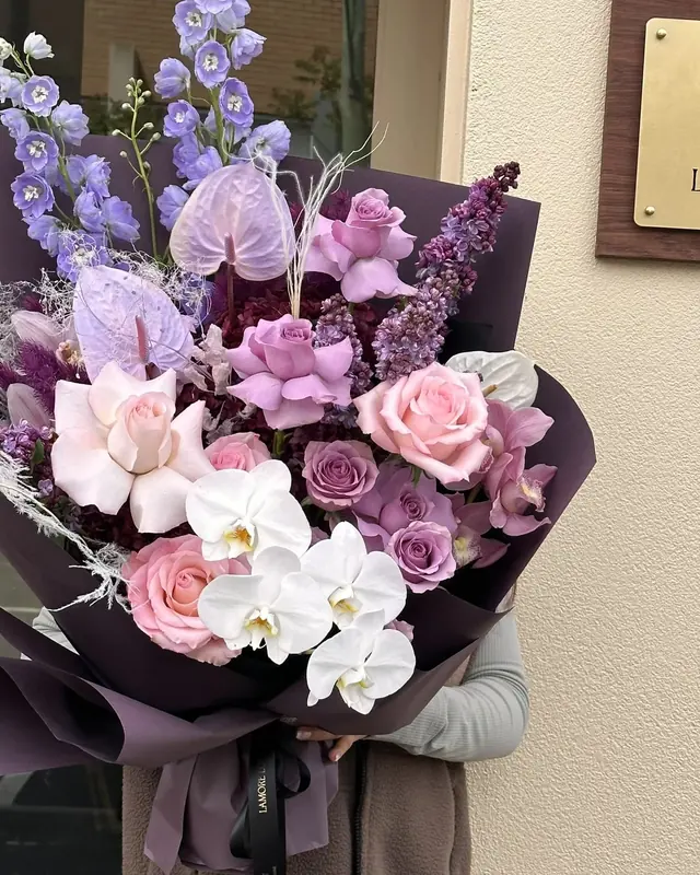 Amethyst Elegance: purple and blush roses, orchids, delphinium and lilac anthurium